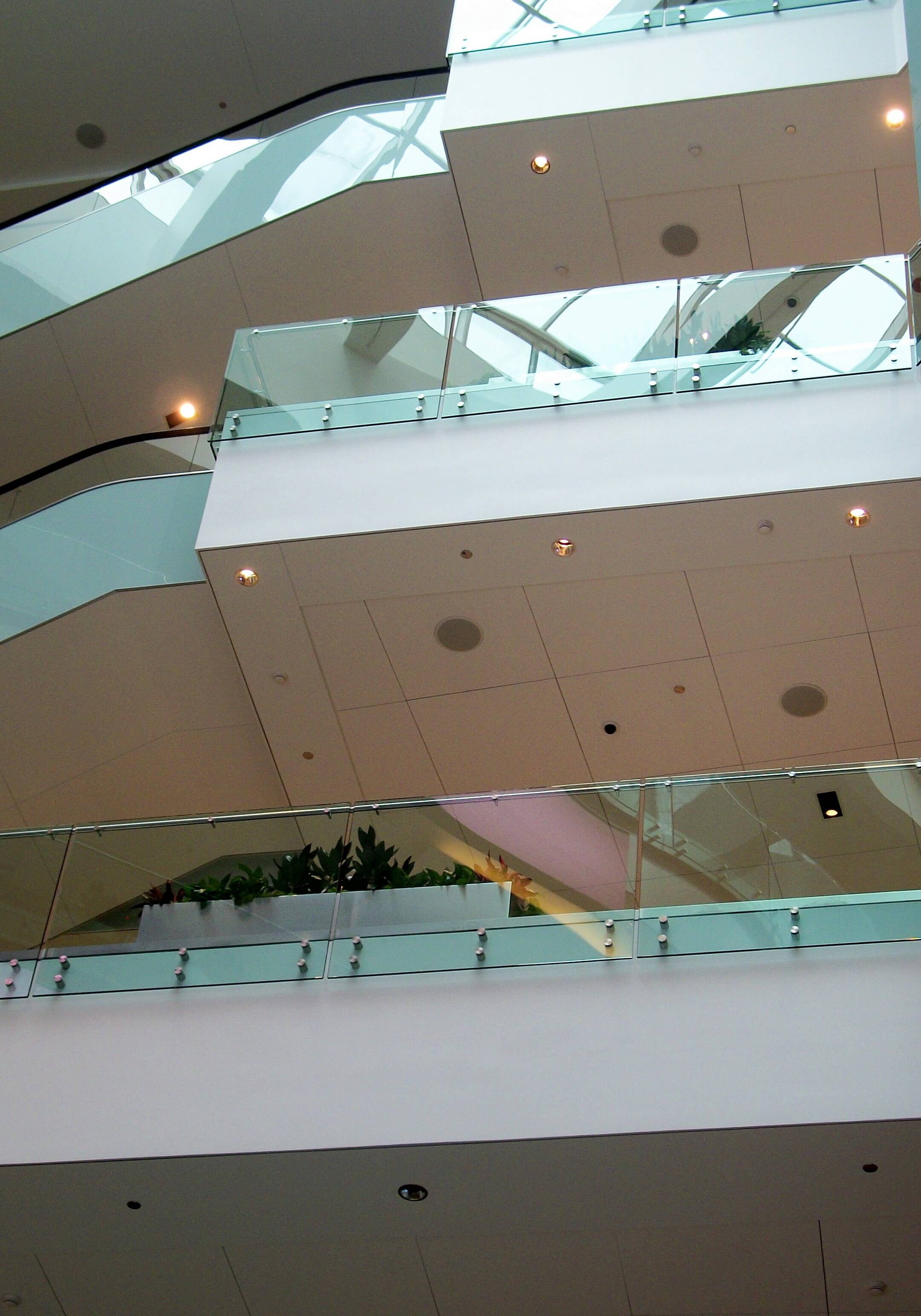 Upward view of 3 levels at a Shopping Mall Chicago, IL, Optik guardrail with clear glass
