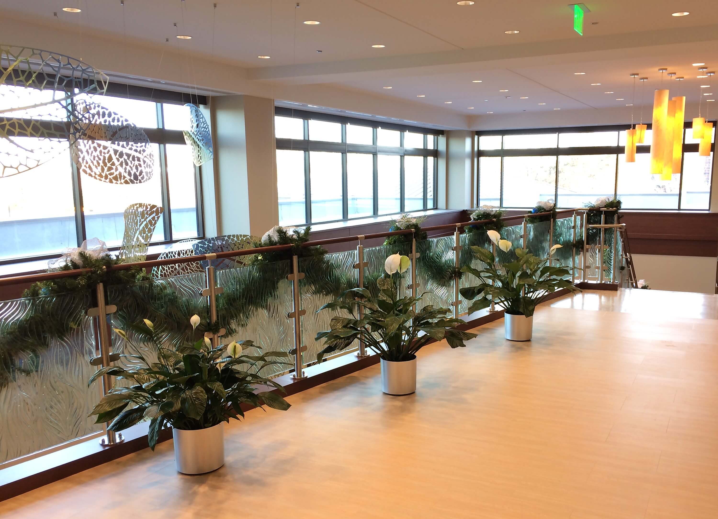 Circum handrail with cast patterned glass infill installation at the Adventist Cancer Ctr, IL.