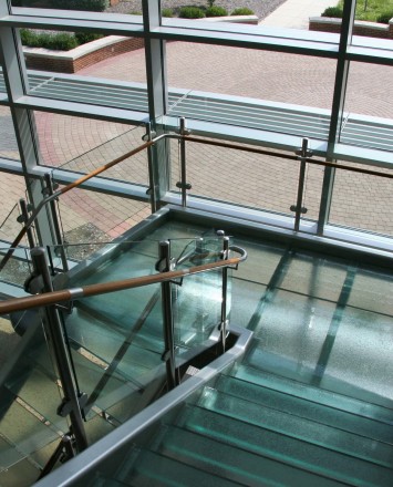 Sunlit view of Circum guardrail installation with glass infill at Blackhawk College, MD.
