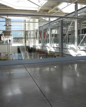 Wide angle view of Ferric guardrail installation with clear glass infill at Welch-Allyn, NY.