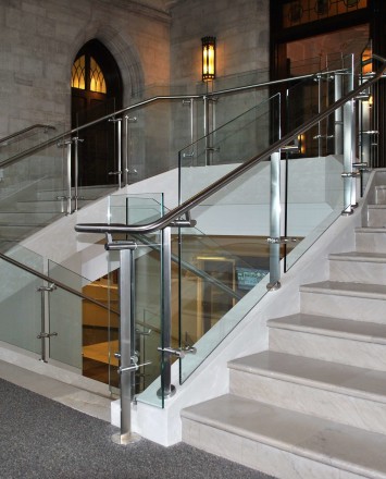 Stairwell view of Konic guardrail installation with glass infill at Mount Saint Mary's, NY.