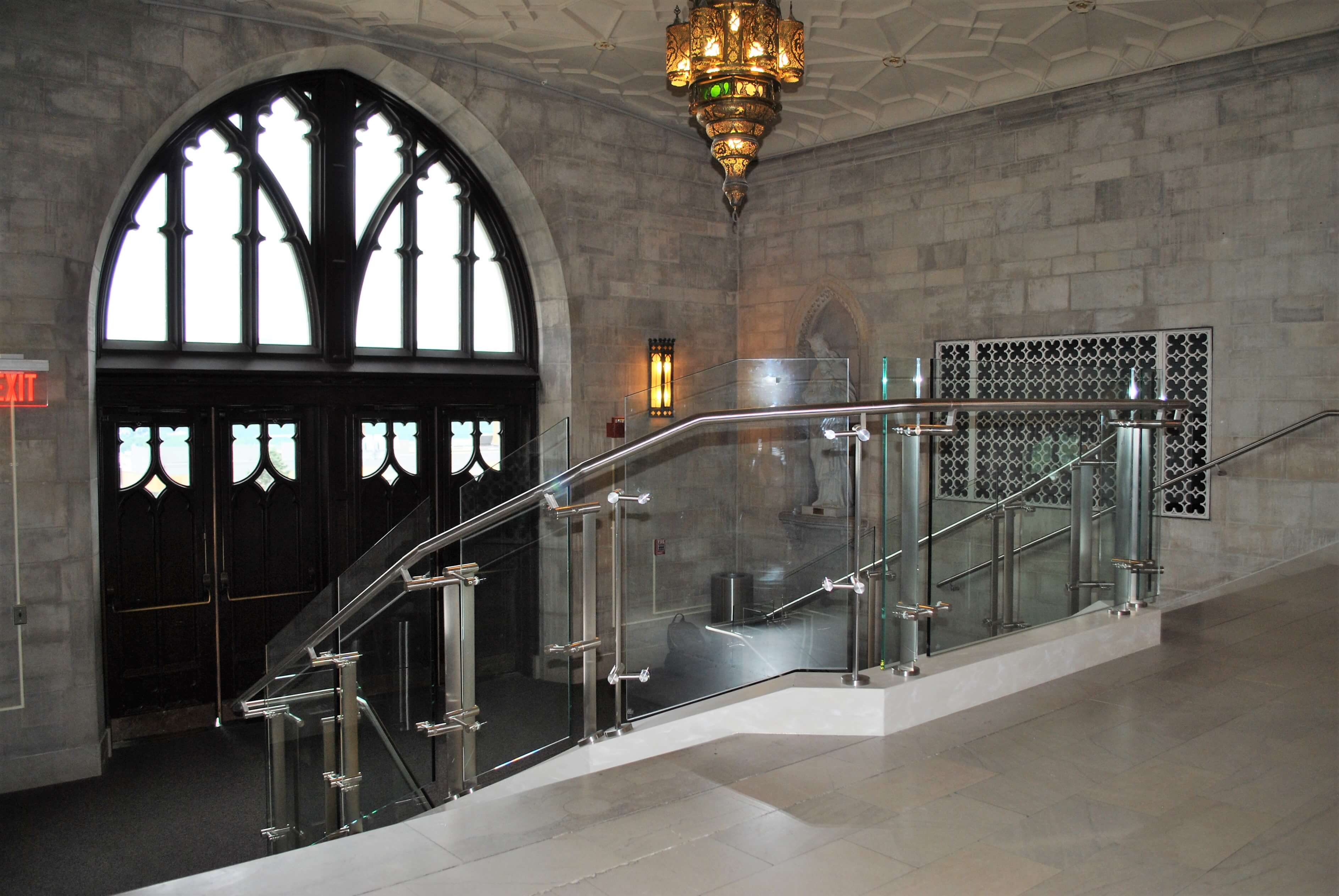 Stairwell view of Konic guardrail installation with glass infill at Mount Saint Mary's, NY.