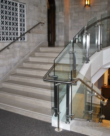 Stairwell view of Konic guardrail installation with glass infill at Mount Saint Mary's, NY.