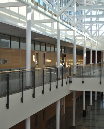 Ferric guardrail with wood top rail and woven mesh infill panels at De Anza College, CA.