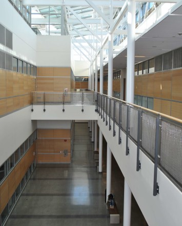 Ferric guardrail with wood top rail and woven mesh infill panels at De Anza College, CA.
