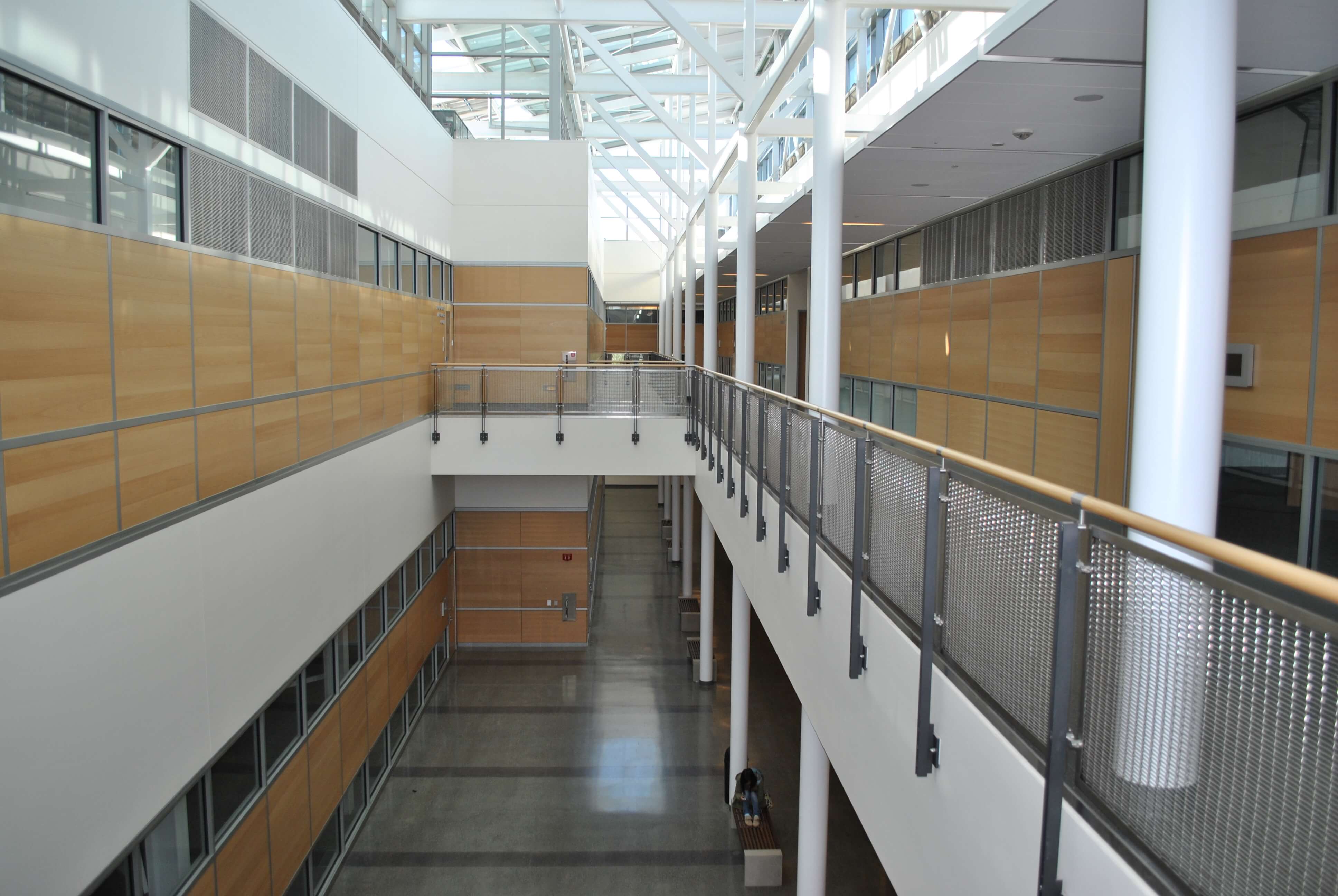 Ferric guardrail with wood top rail and woven mesh infill panels at De Anza College, CA.