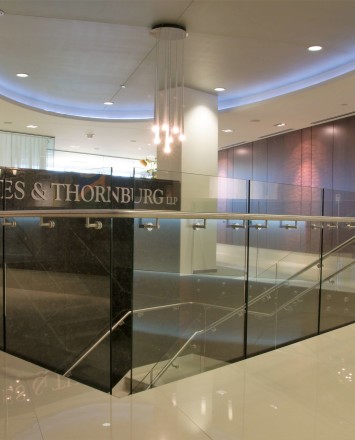 Upward lobby view of Barnes and Thornberg law offices, CA, Optik guardrail with clear glass