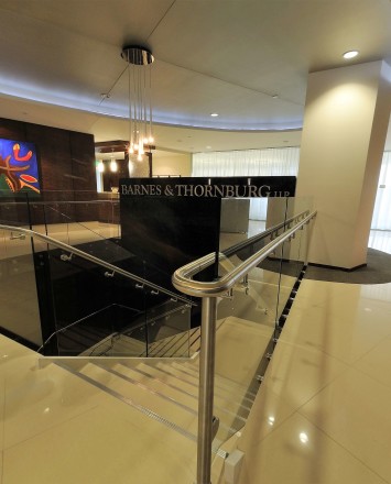 Upward lobby view of Barnes and Thornberg law offices, CA, Optik guardrail with clear glass