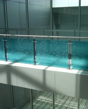 Angled view of Ferric guardrail with glass infill installation in the RCC Lobby, New York Transit, NY.