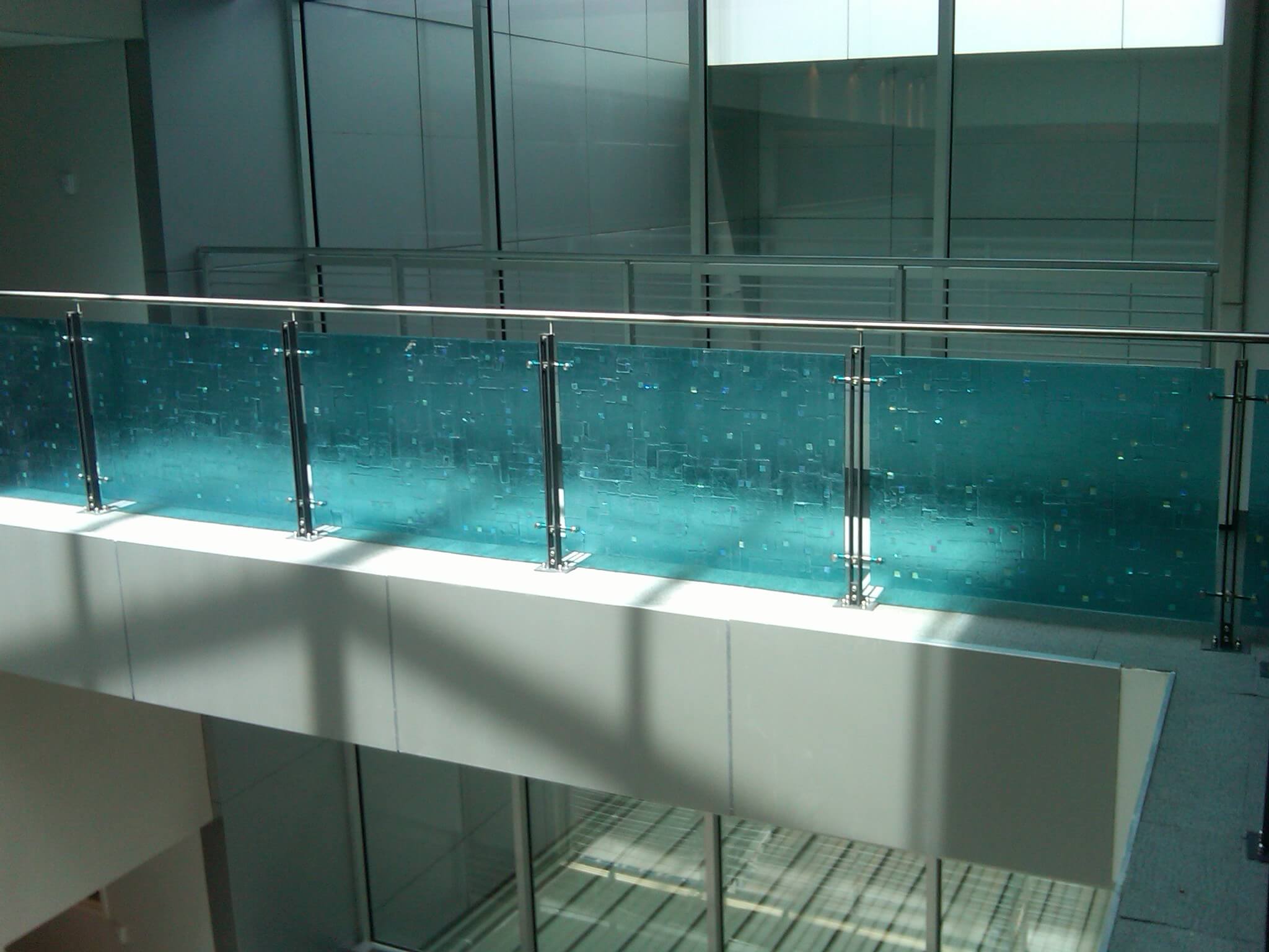 Angled view of Ferric guardrail with glass infill installation in the RCC Lobby, New York Transit, NY.