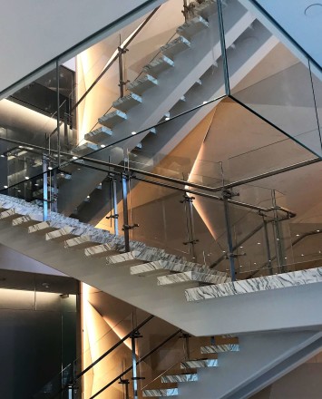 Atrium stair at Market Axess offices, Kubit glass railing system and Optik smoke baffles.