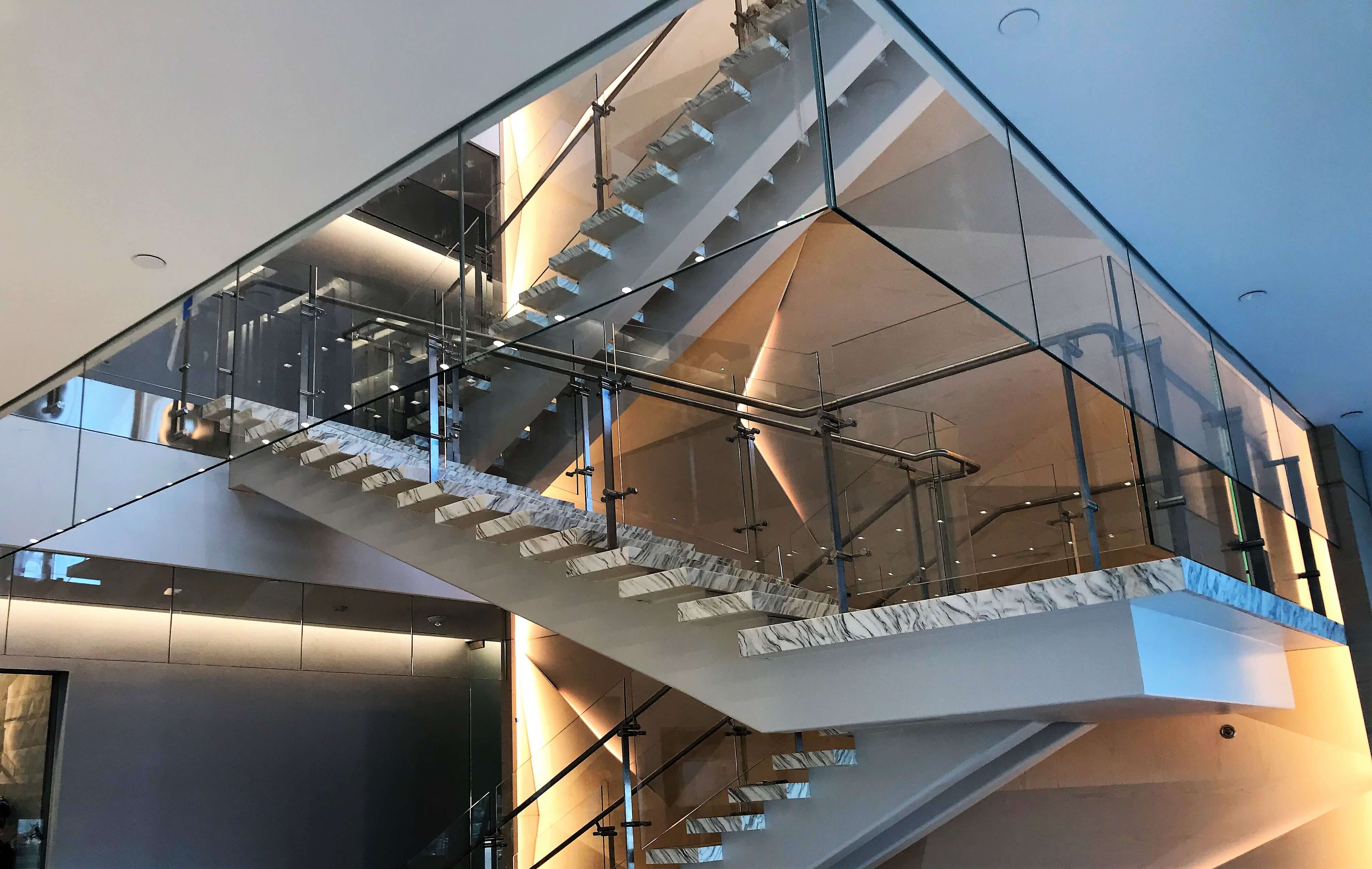 Atrium stair at Market Axess offices, Kubit glass railing system and Optik smoke baffles.