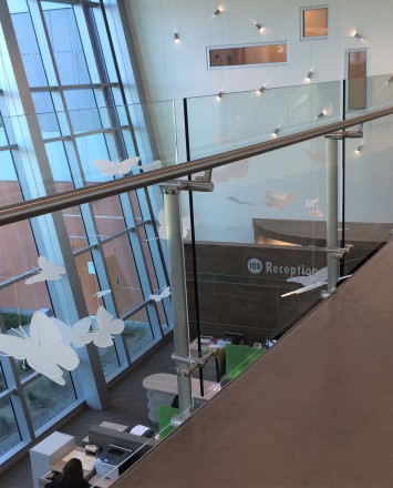 Konic guardrail installation with glass infill at Kaiser Permanente, CA.