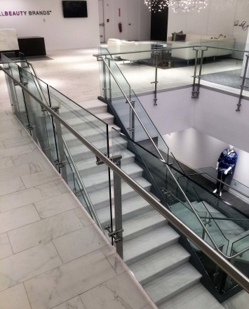 Stair at Full Beauty Brands offices, NY, Kubit glass railing system.