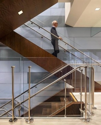 Staircase view of Kubit railing system with glass infill at a Shepards Mullin, CA.