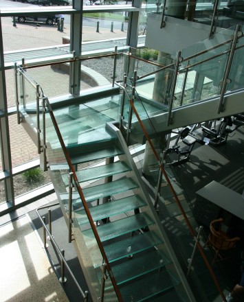 Circum round guardrail with glass infill and wood top rail at McDaniels College, MD