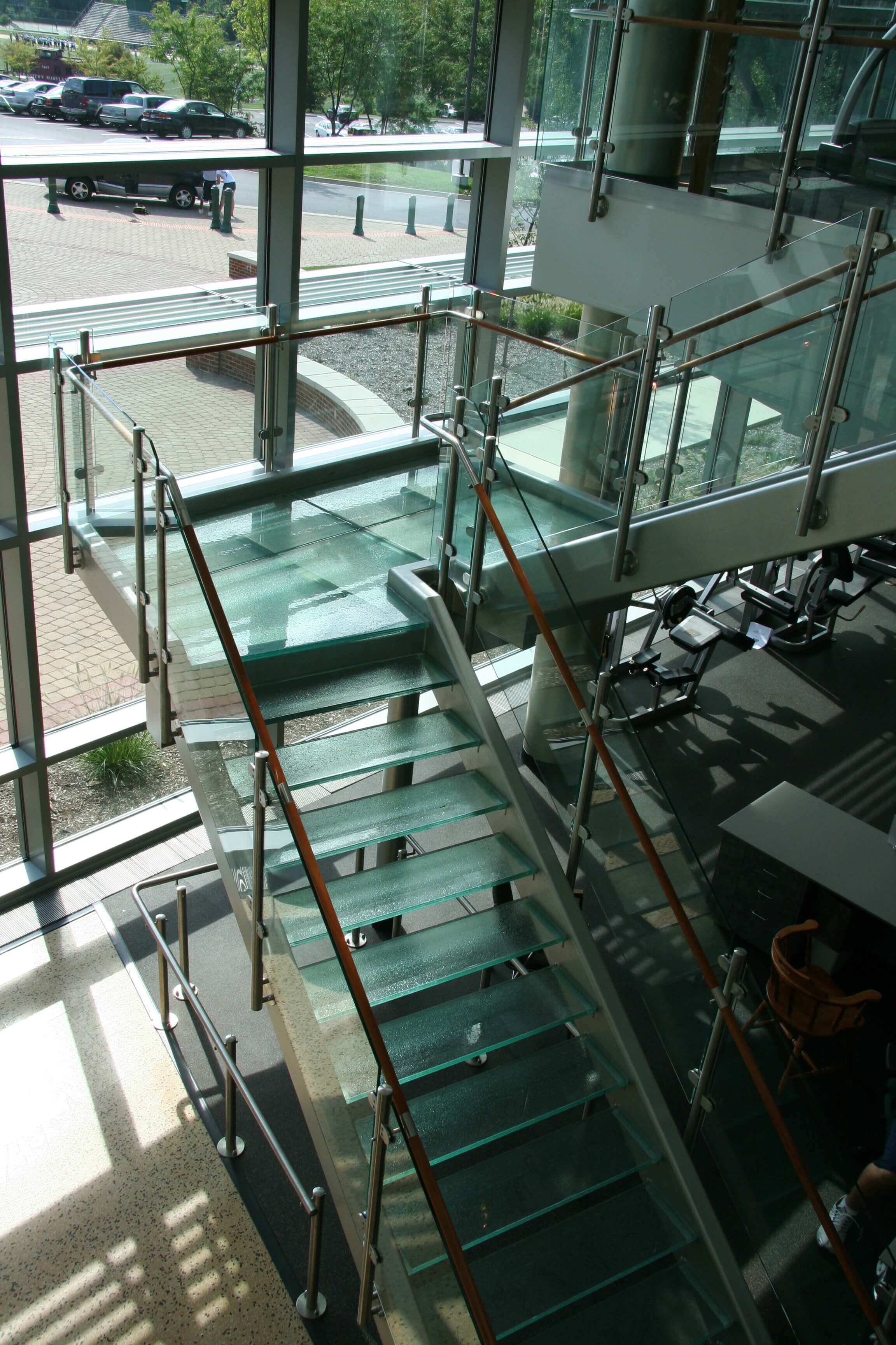 Circum round guardrail with glass infill and wood top rail at McDaniels College, MD