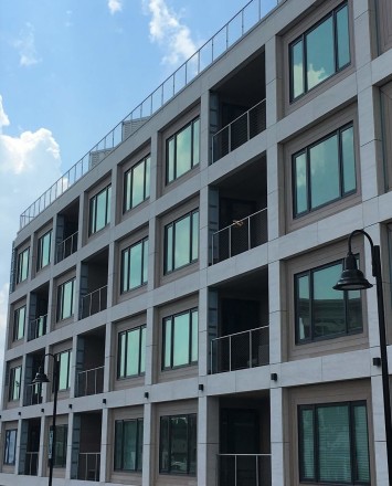 Circum round guardrail with stainless steel infill mesh attached via cable infill rail at Monroe Condominiums, NJ.