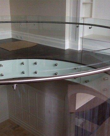 Second floor downward view in Private Residence, Washington DC, Optik guardrail with curved clear glass