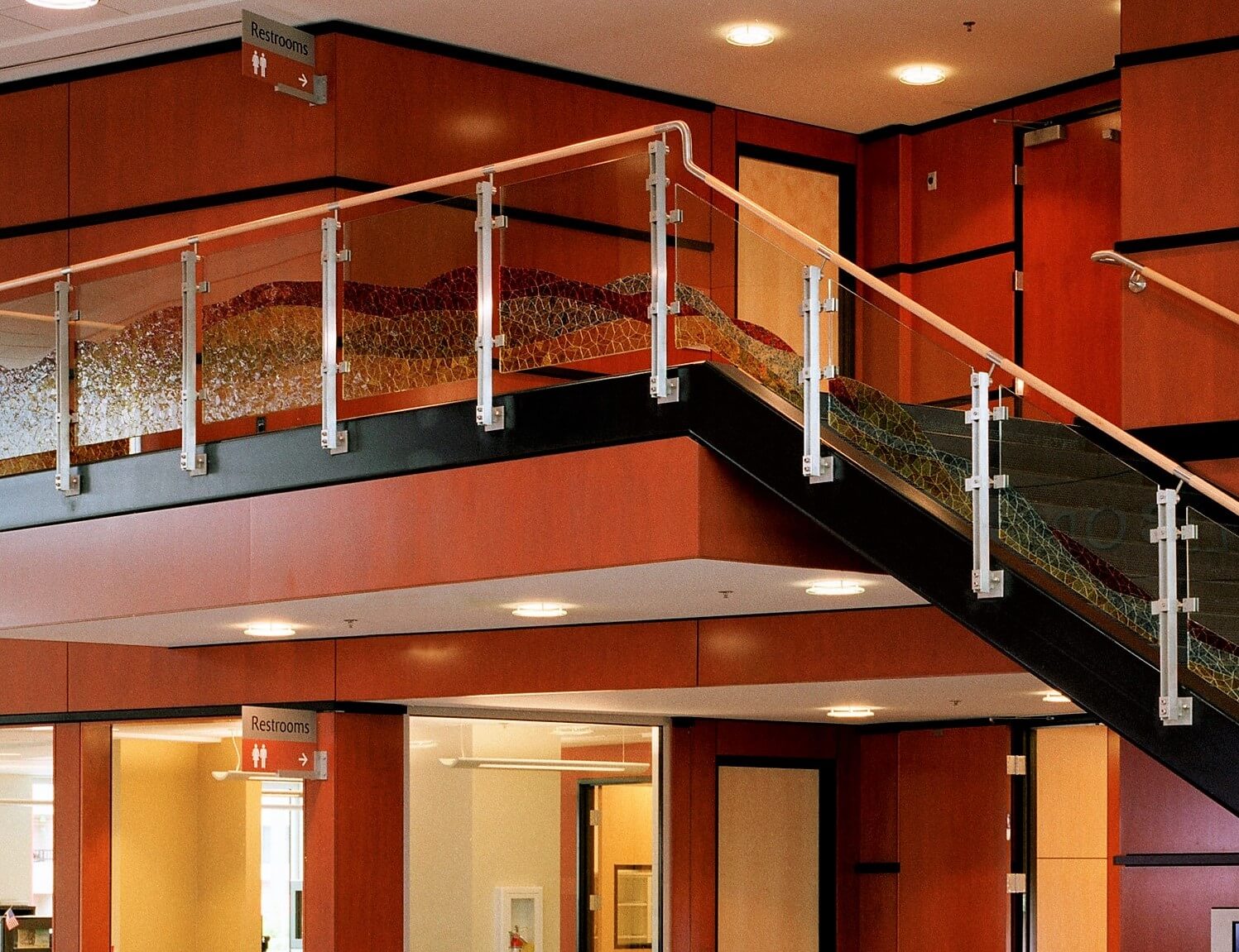 inox guardrail with cast patterned glass infill installation at the Hillsboro Civic Ctr, OR.