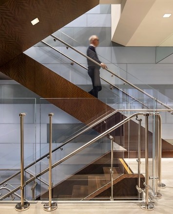 Staircase view of Kubit railing system with glass infill at a Shepards Mullin, CA.