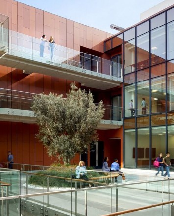 Outdoors side angled view at University of California San Diego, CA, Optik guardrail with clear glass and wood handrail