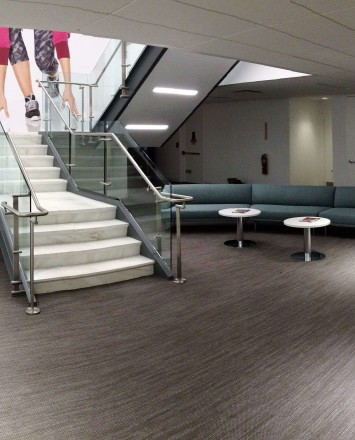 Stair at Full Beauty Brands offices, NY, Kubit glass railing system.