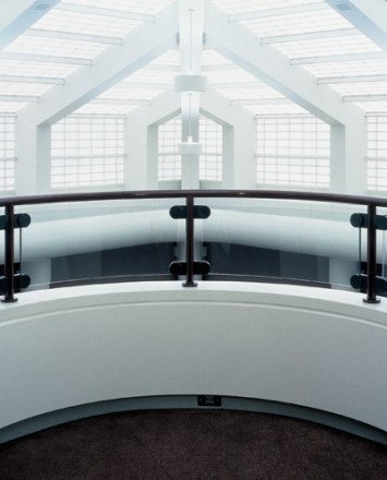 Overlooking sunlit view of Hewi guardrail with glass infill and skylights at Nissan R&D Facility, MI.