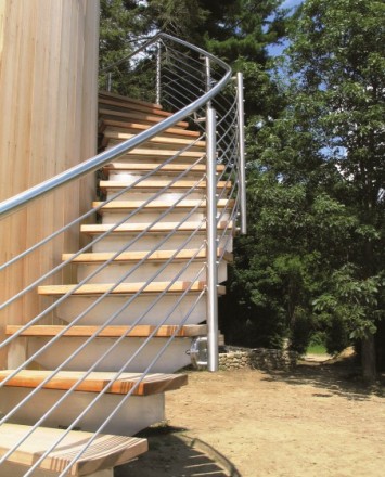 Upward view of curved Pool Cabana stairwell, Private Residence, CT, CIRCUM guardrail with stainless steel curved infill rails