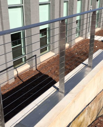 View of Veeco Instruments, NJ, KOTO guardrail with posts welded to stainless steel plate.