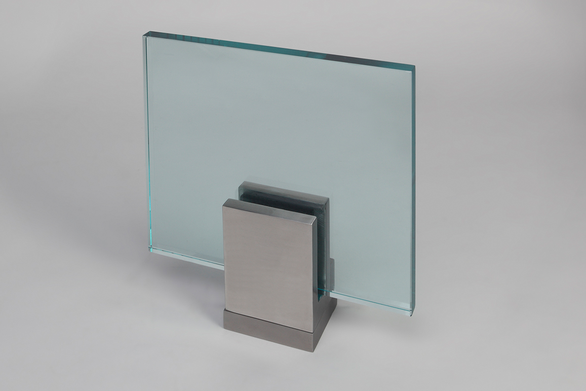 Closeup Studio shot of metal square Optik POD mounting hardware with glass infill