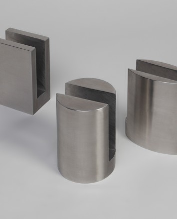 Closeup Studio shot of three types of metal Optik POD mounting hardware