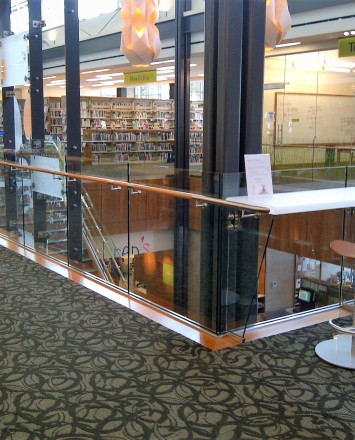 Corner view of Los Gatos Library, Optik Shoe with wood handrails and custom shelf