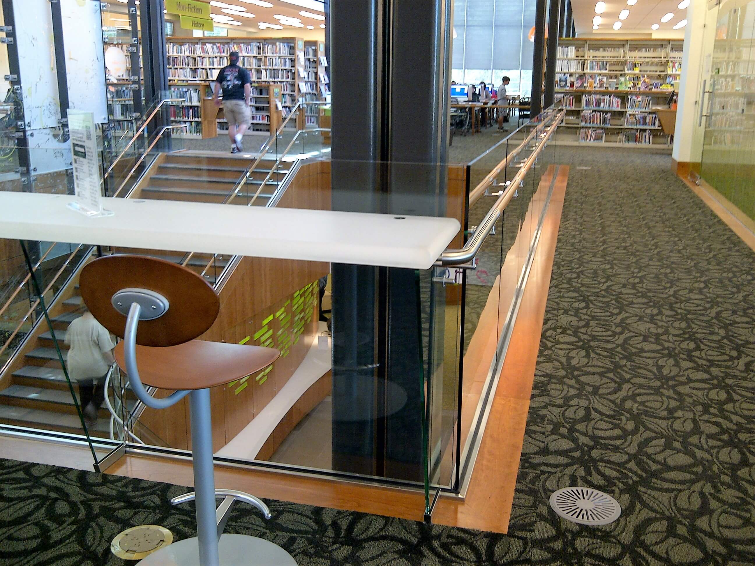 Corner view of Los Gatos Library, Optik Shoe with wood handrails and custom shelf