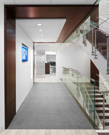 White and wood hallway with Smoke baffle system with Konic railing system